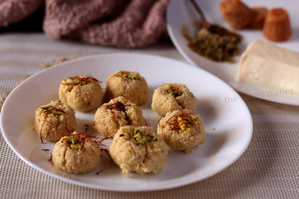 Mava Pedha in focus with assorted Indian sweets in the background, creating a festive dessert spread.