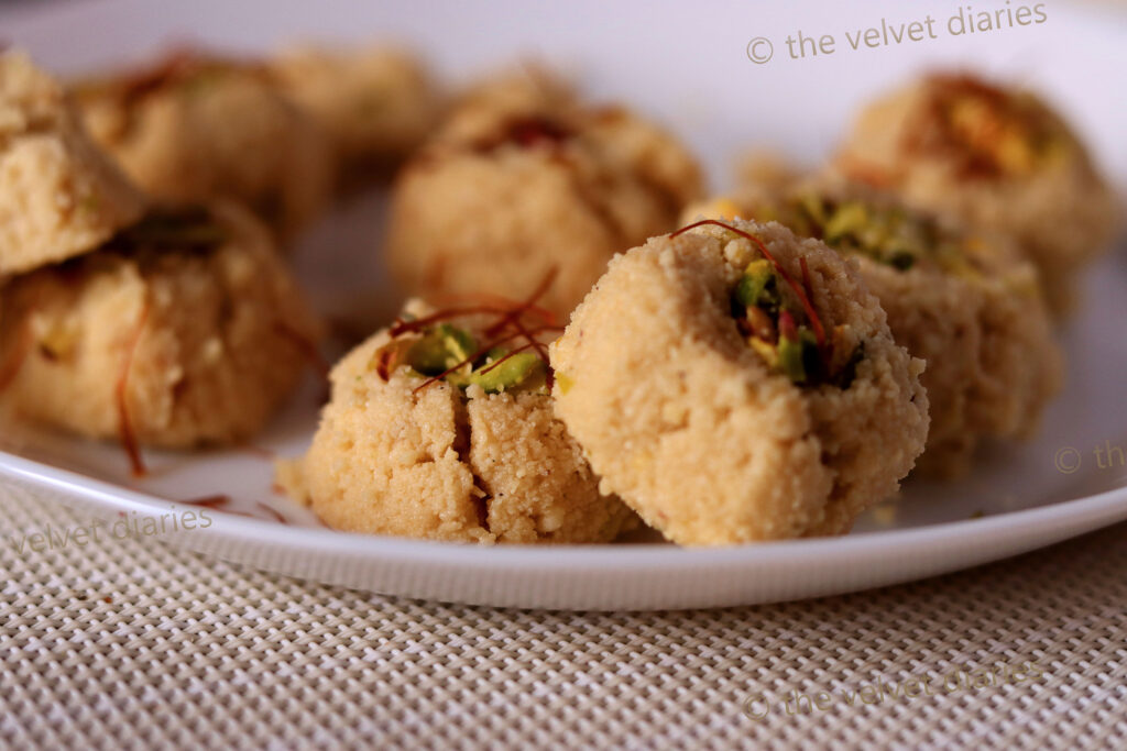 A stack of Mava Pedha garnished with almonds, arranged for a premium food photography shot.