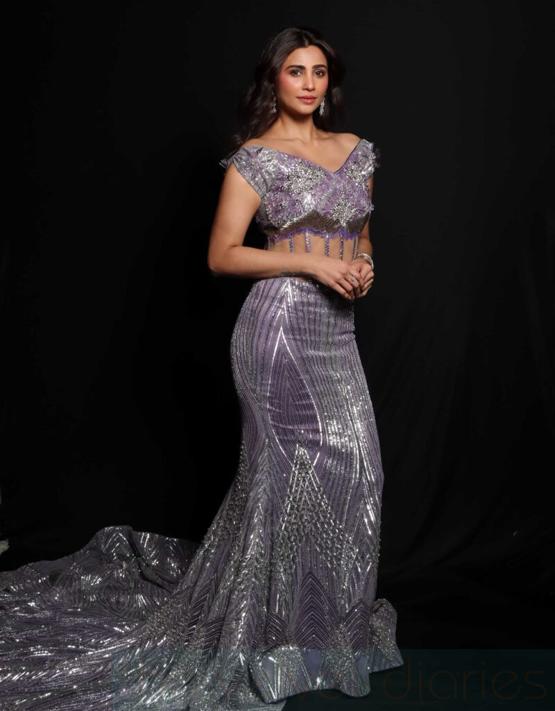 Celebrity presence captured during a live fashion showcase.