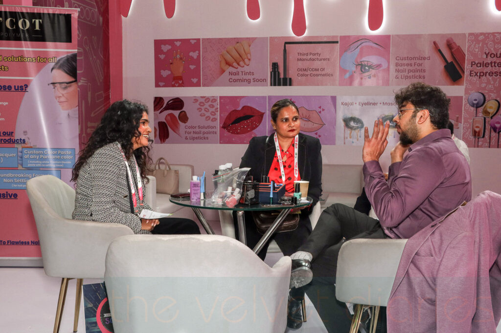 Client interaction and business discussion at cosmetics exhibition booth