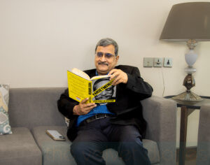 Corporate professional reading a book in office lounge during lifestyle business photoshoot