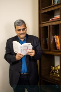 Business portrait of an executive reading a book in a corporate office environment