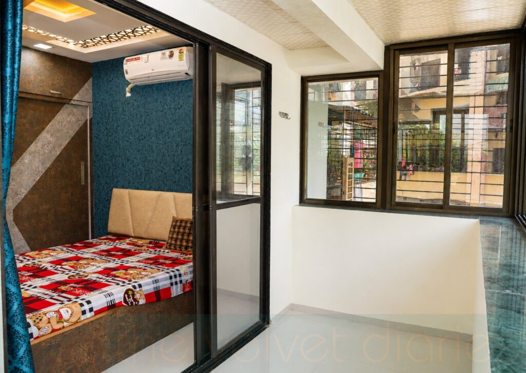 Compact bedroom and window space interior photographed for residential architectural portfolio in Mumbai.