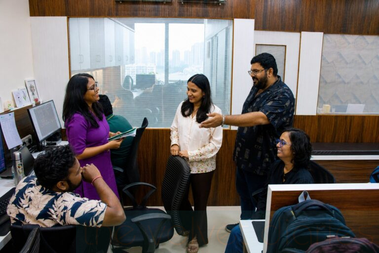 Employees collaborating inside a modern corporate office workspace in Mumbai