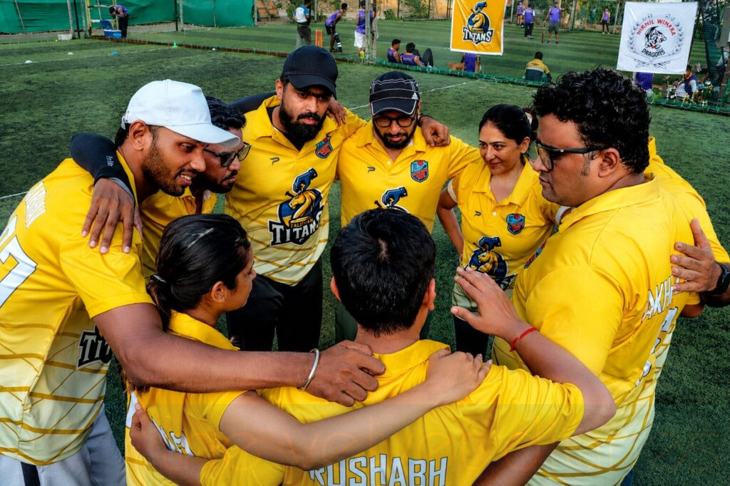 Corporate employee team huddle during cricket networking event in Mumbai