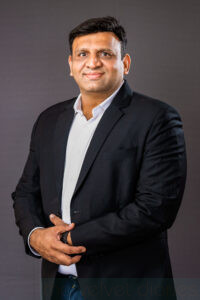 Executive corporate headshot of business leader photographed on dark background in Mumbai