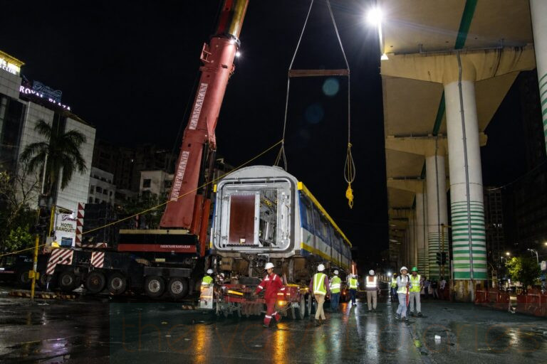 Suspended metro coach during industrial crane operation photography in Mumbai