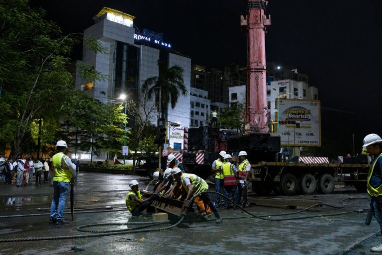 Industrial engineering operation photography with workers and crane activity during metro infrastructure execution
