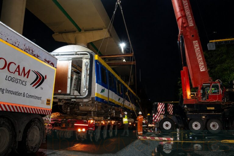 Industrial photography of metro rail coach unloading operation at night in Mumbai