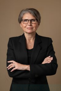 Professional business headshot of an executive with crossed arms photographed for corporate branding