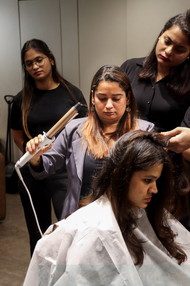 Professional hair stylist Priya Tekchandani from white Feather Studio in Mumbai demonstrating advanced hairstyling techniques during a live salon training workshop in Mumbai.