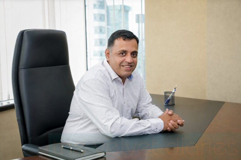 Executive business portrait of a senior professional seated at his office desk in Mumbai