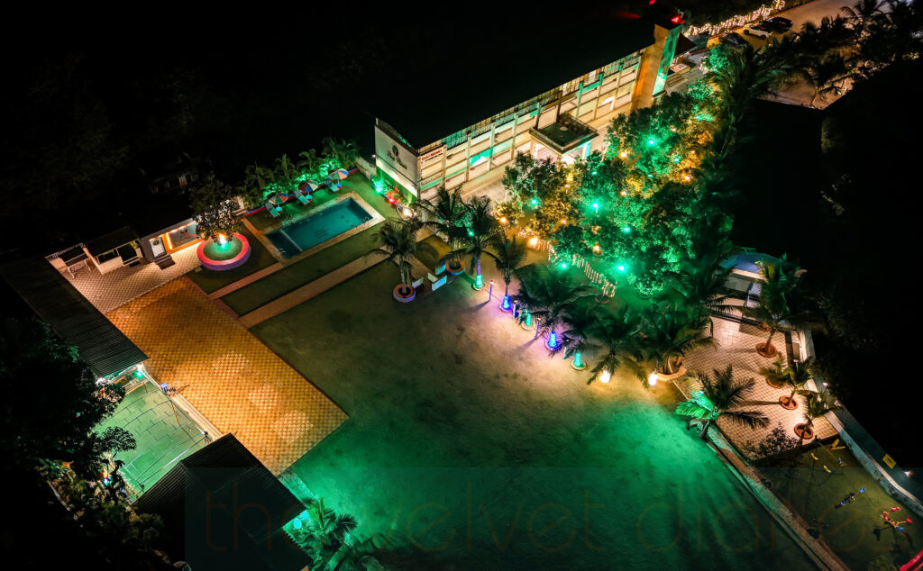 Night aerial drone photography showing an illuminated resort property in Mumbai