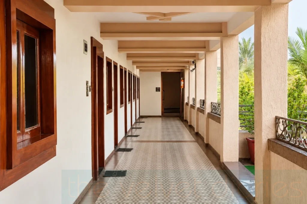 Commercial property interior photography showcasing an open corridor with wooden doors, tiled flooring, architectural columns and natural light for property marketing in Mumbai.