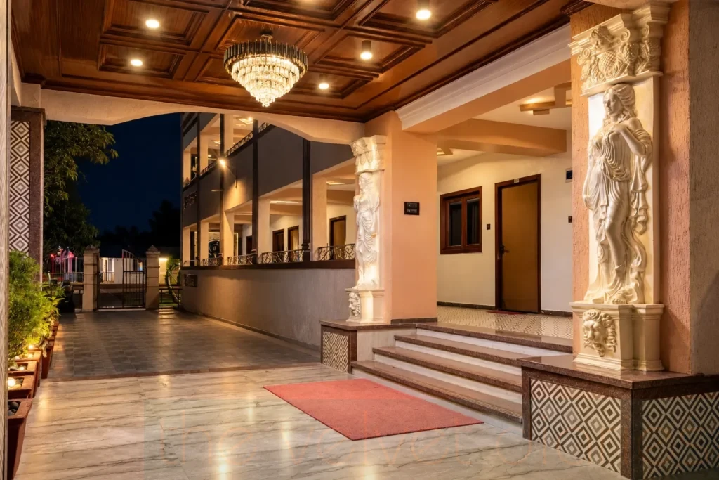 Commercial property photography in Mumbai showcasing an illuminated entrance with decorative columns, marble steps and warm architectural lighting.