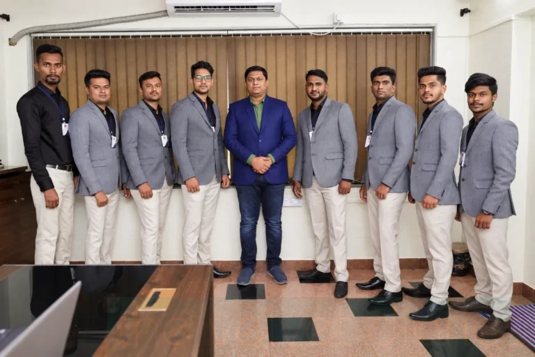 Corporate employee team photography in Mumbai featuring a manager and male staff members in coordinated professional business attire.