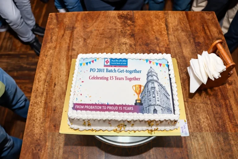 Corporate event detail photography featuring the Central Bank of India PO 2011 batch reunion cake commemorating 15 years together.