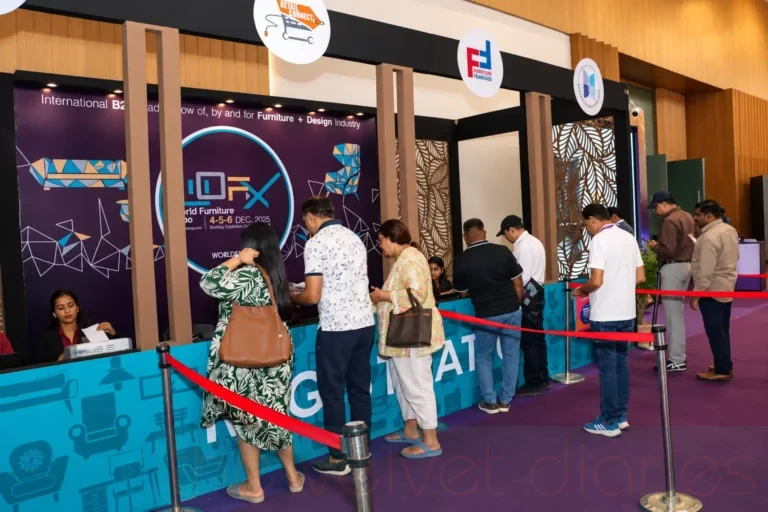 Visitors queuing at a registration counter during a furniture and design trade fair in Mumbai.