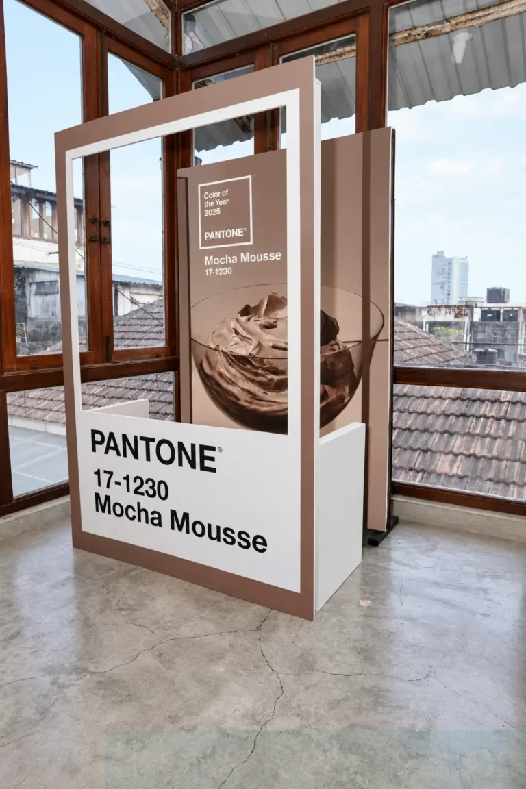Exhibition display photography showcasing the Pantone Colour of the Year 2025, Mocha Mousse, in a framed installation at a design event.