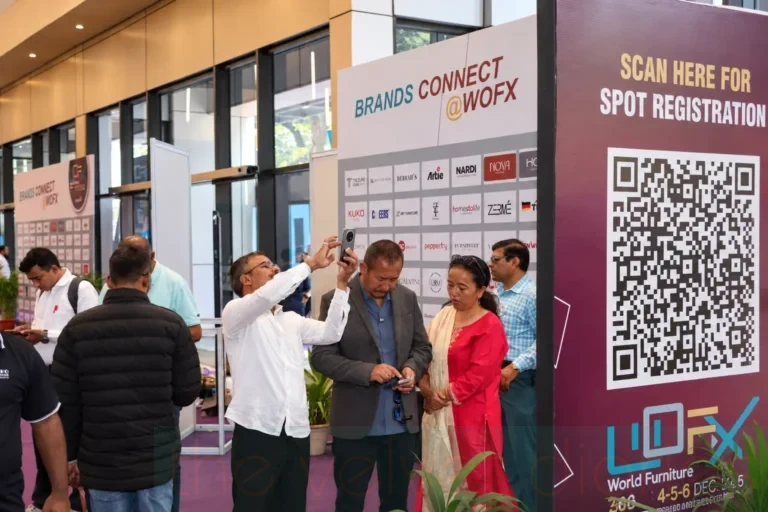Brands Connect registration signage and QR code at a furniture and design exhibition.