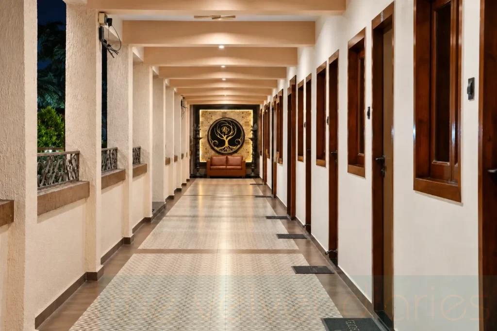 Hospitality interior photography showcasing a property corridor with patterned flooring, wooden doors and a decorative feature wall for commercial property marketing in Mumbai.