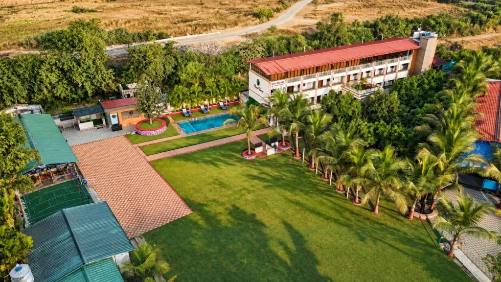 Aerial resort photography showing landscaped grounds, pool and surrounding property in Mumbai