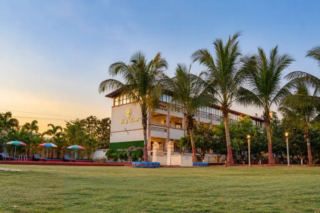 Resort exterior photography showcasing Rayj Resort’s multi-storey property, landscaped grounds and palm-lined entrance for hospitality marketing.