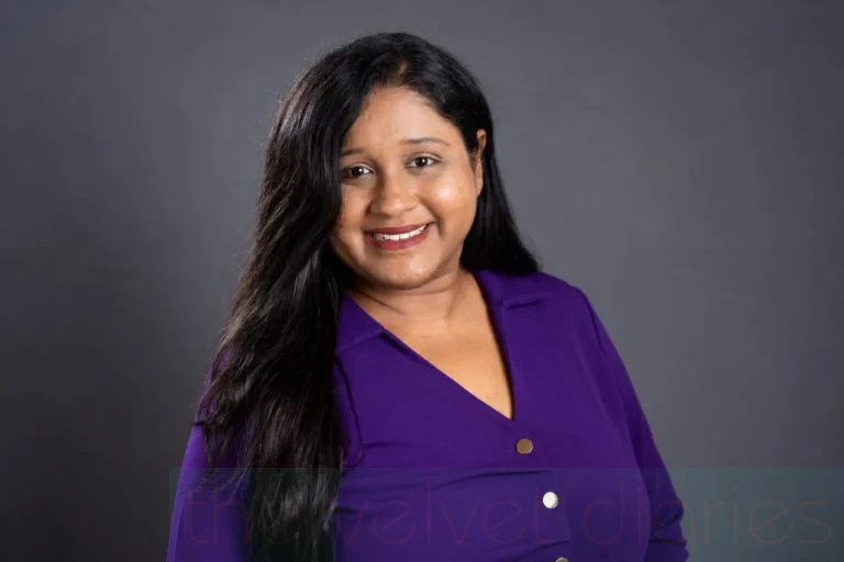 Professional close-up headshot of a smiling female corporate executive in purple attire by The Velvet Diaries